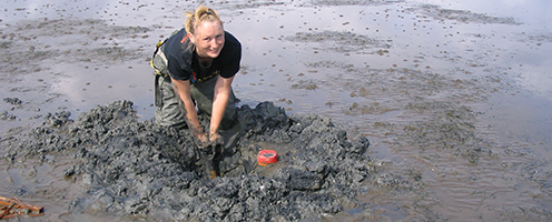 Student knee deep in mud