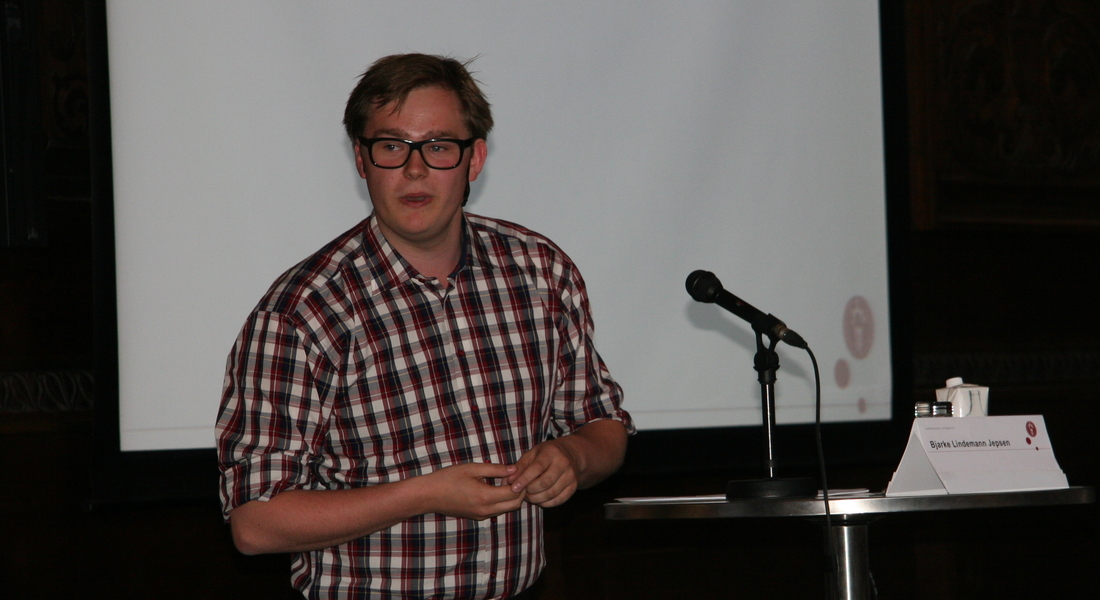 The vice-president of 'Studenterrådet' (the student union) speaking  into a microphone